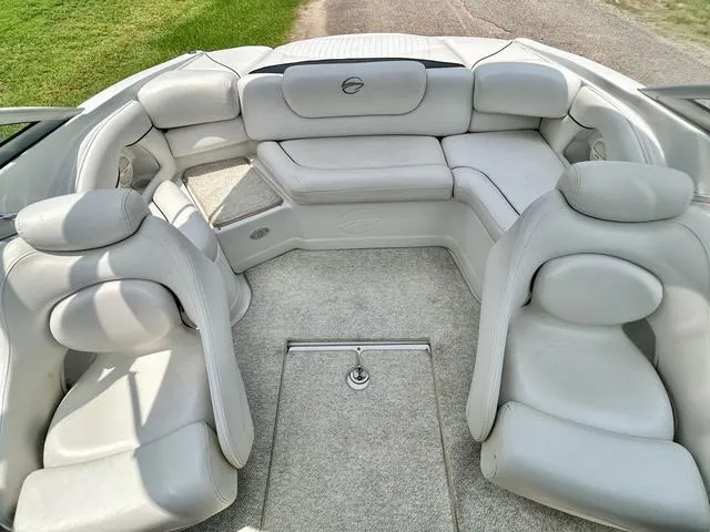 Slide: The Image of 2005 Crownline 216 LS boat interior with plush white seating and carpeted flooring. - 32