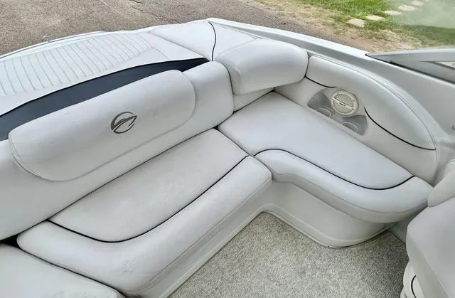 Slide: The Image of 2005 Crownline 216 LS boat interior with white cushioned seating and sleek design. - 33