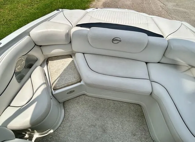 Slide: The Image of 2005 Crownline 216 LS boat interior with white cushioned seating and cup holders. - 36
