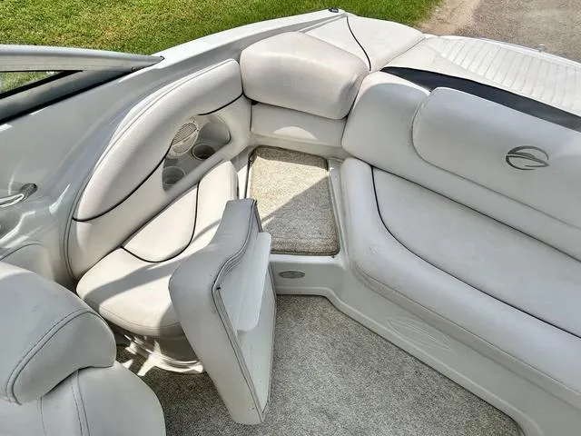 Slide: The Image of 2005 Crownline 216 LS boat interior with white seating and carpeted floor. - 37