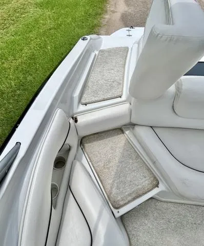 Slide: The Image of 2005 Crownline 216 LS boat interior with white seating and carpeted flooring. - 38