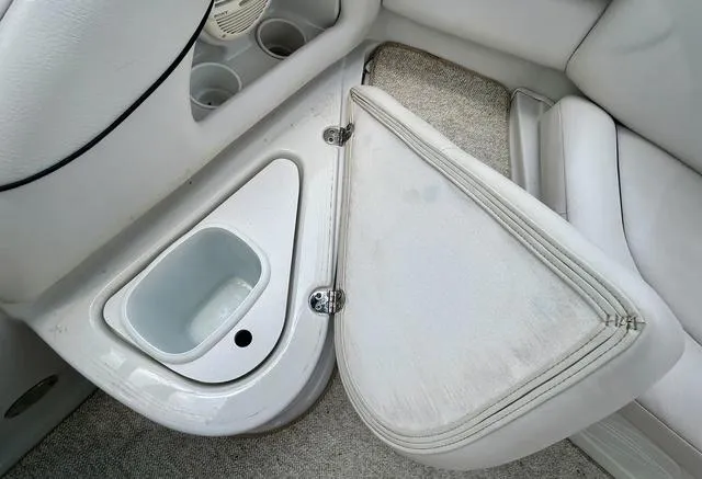 Slide: The Image of 2005 Crownline 216 LS boat interior with storage compartment and cup holders. - 39