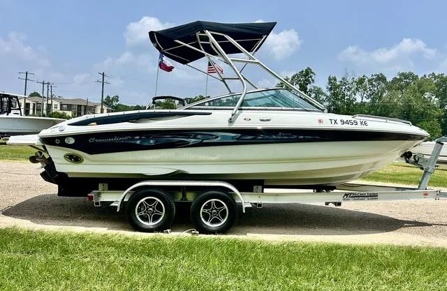 Slide: The Image of 2005 Crownline 216 LS boat on trailer with canopy, parked outdoors. - 4