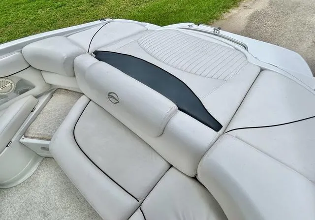 Slide: The Image of 2005 Crownline 216 LS boat interior with white cushioned seating and black accents. - 40
