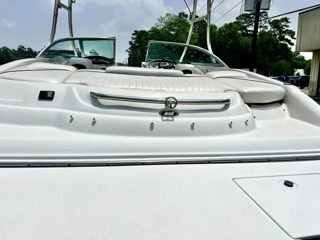 Slide: The Image of 2005 Crownline 216 LS boat with white seating and sleek design, docked outdoors. - 44