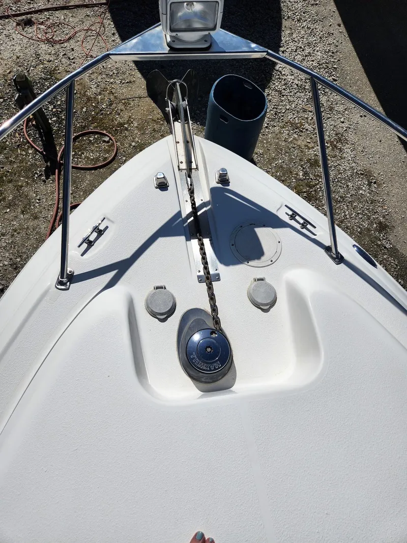 Slide: The Image of 2006 Larson Cabrio 260 boat bow with anchor and railing, viewed from above. - 11