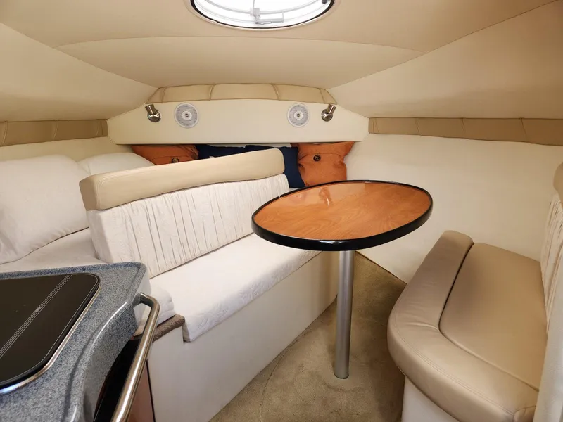 Slide: The Image of 2006 Larson Cabrio 260 cabin interior with seating and table. - 16