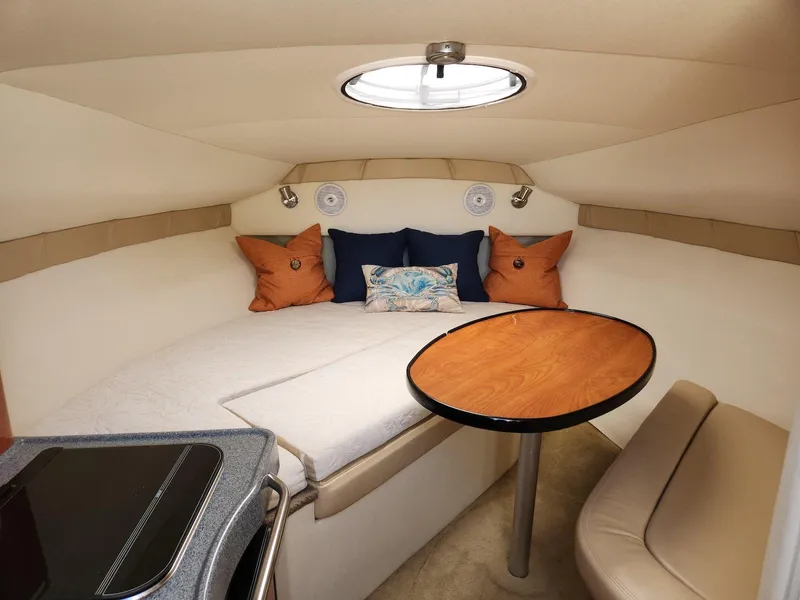 Slide: The Image of 2006 Larson Cabrio 260 cabin interior with cozy seating and table. - 27