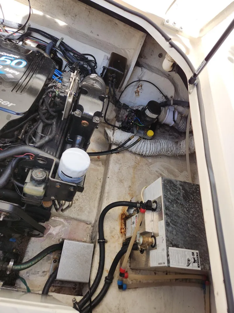 Slide: The Image of Engine compartment of a 2006 Larson Cabrio 260 boat, showing mechanical components and wiring. - 28