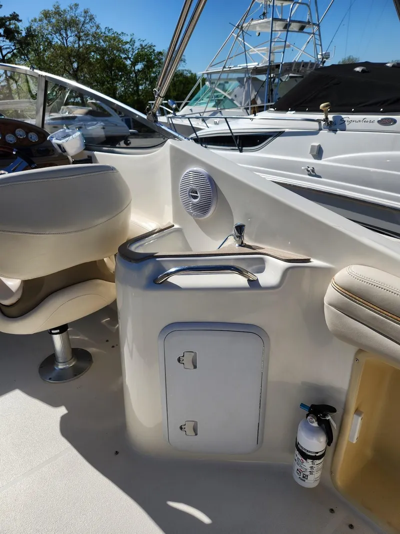 Slide: The Image of 2006 Larson Cabrio 260 boat interior with seating, control panel, and safety equipment. - 33