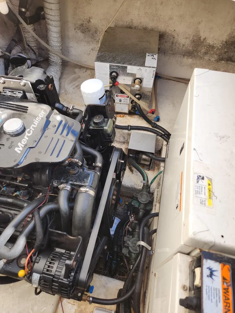 Slide: The Image of Engine compartment of a 2006 Larson Cabrio 260 boat, featuring a MerCruiser engine. - 40