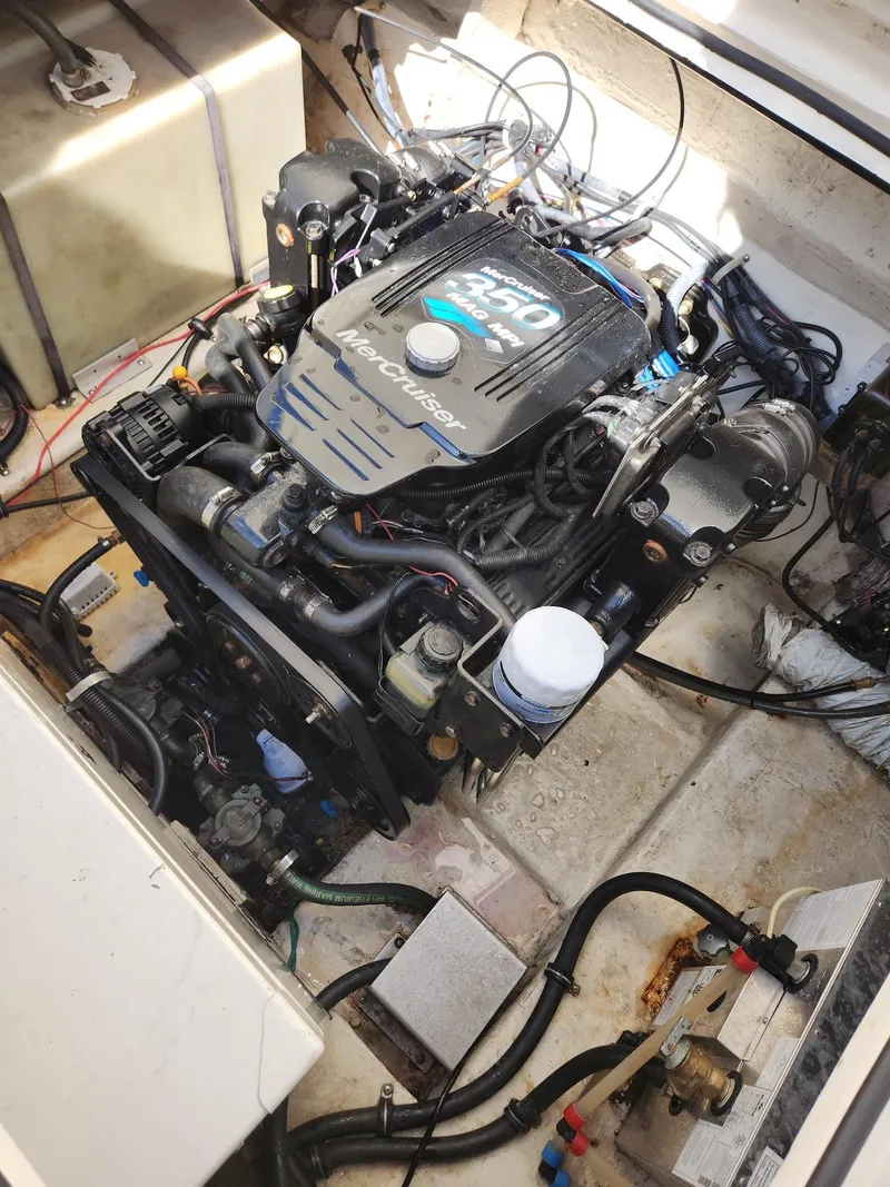 Slide: The Image of Engine compartment of a 2006 Larson Cabrio 260 boat, showcasing the engine and wiring. - 41