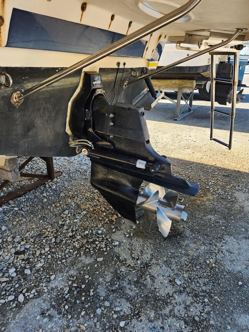 Slide: The Image of 2006 Larson Cabrio 260 boat stern drive and propeller on gravel surface. - 42