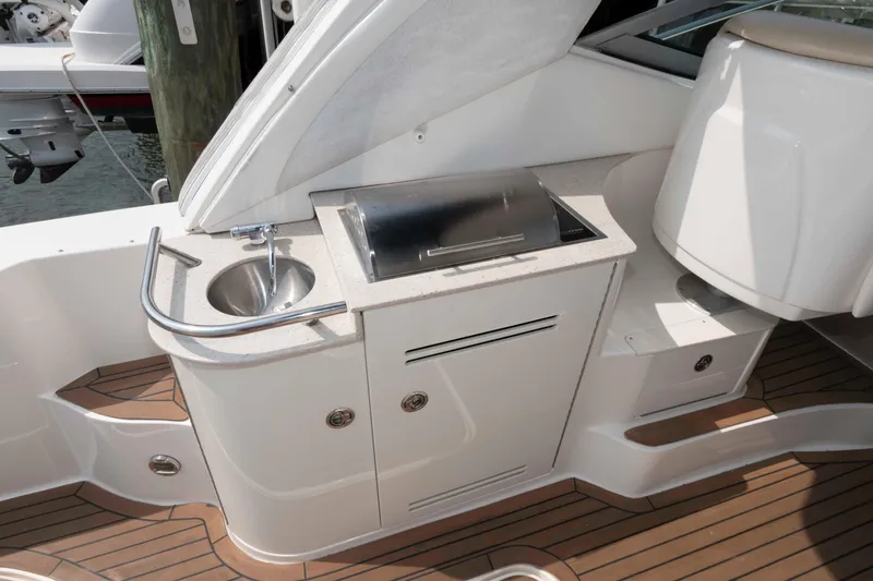 Slide: The Image of 2008 Sea Ray 330 Sundancer boat kitchenette with sink and grill on deck. - 10