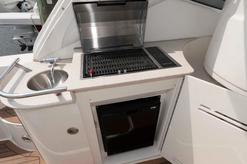 Slide: The Image of Outdoor kitchenette on 2008 Sea Ray 330 Sundancer with grill, sink, and mini fridge. - 11