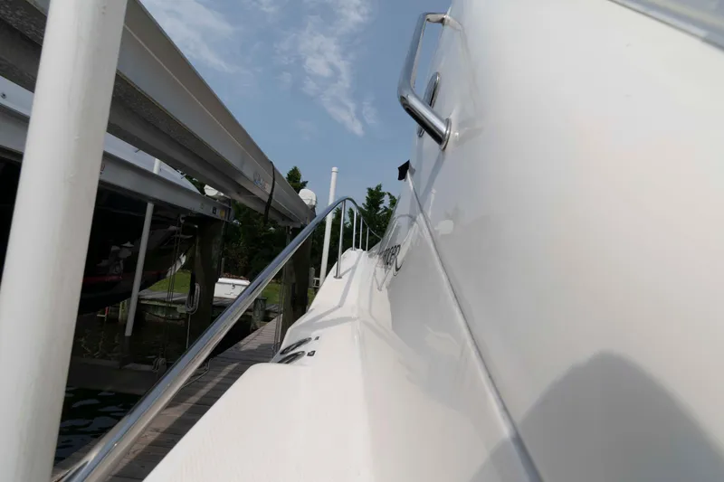 Slide: The Image of 2008 Sea Ray 330 Sundancer yacht, side view with railing, docked under clear sky. - 13