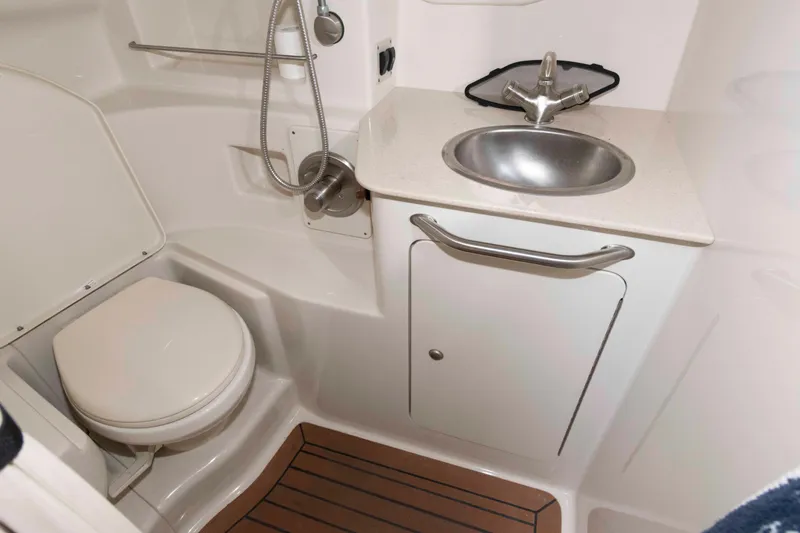 Slide: The Image of 2008 Sea Ray 330 Sundancer bathroom with sink, toilet, and wooden floor. - 20