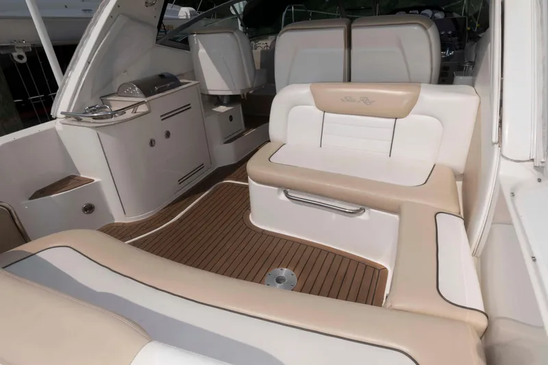 Slide: The Image of 2008 Sea Ray 330 Sundancer interior with beige seating and wood flooring. - 4