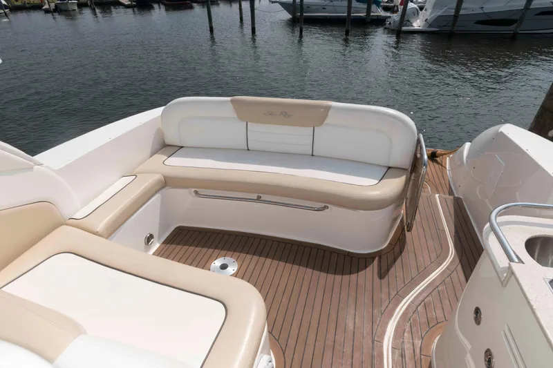 Slide: The Image of 2008 Sea Ray 330 Sundancer boat with beige and white seating on deck. - 5