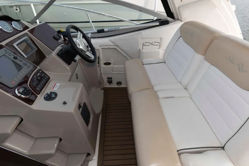 Slide: The Image of 2008 Sea Ray 330 Sundancer cockpit with beige seating and modern control panel. - 6