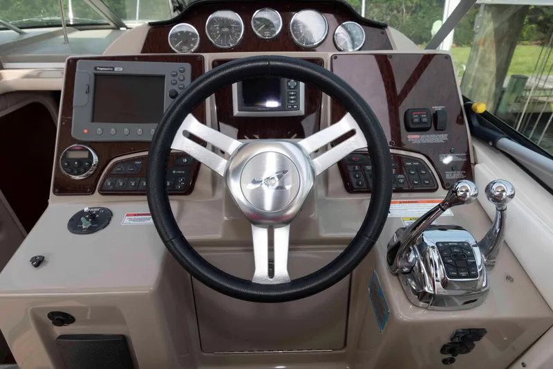 Slide: The Image of 2008 Sea Ray 330 Sundancer helm with steering wheel, gauges, and controls. - 8