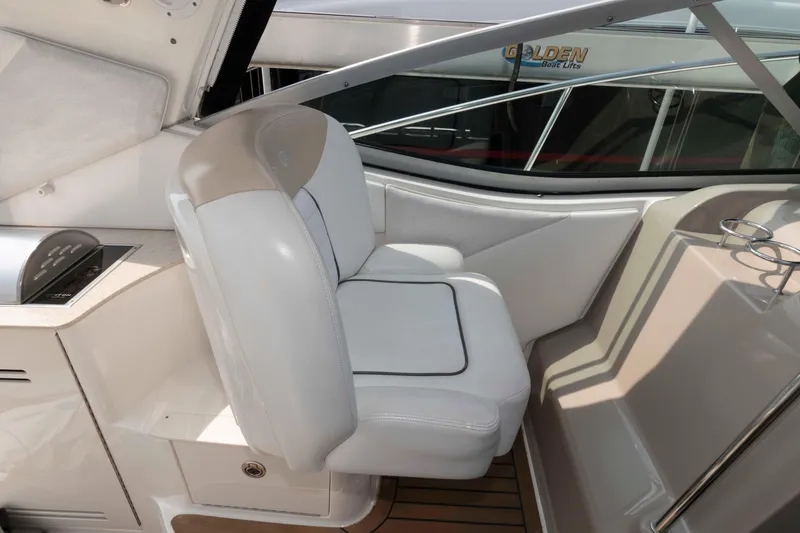 Slide: The Image of 2008 Sea Ray 330 Sundancer cockpit with white seating and sleek design. - 9