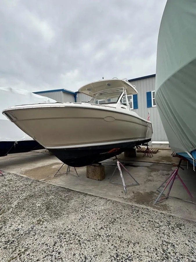 Slide: The Image of 2021 Cutwater C-24 CW boat on stands in a storage yard. - 2