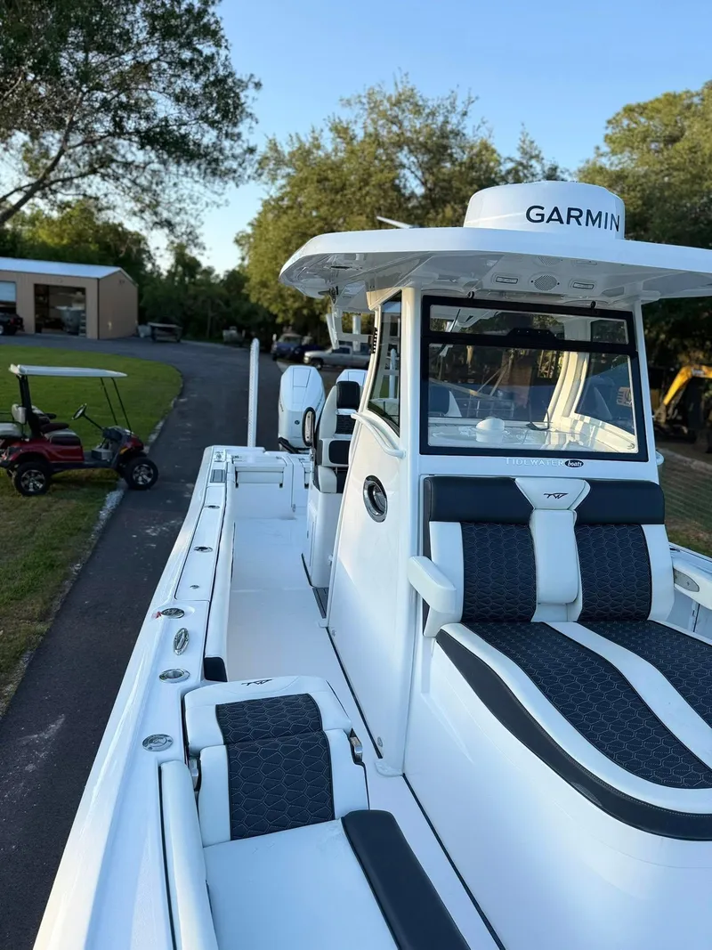 Slide: The Image of 2025 Tidewater 3100 Carolina Bay boat with Garmin equipment, docked outdoors. - 11