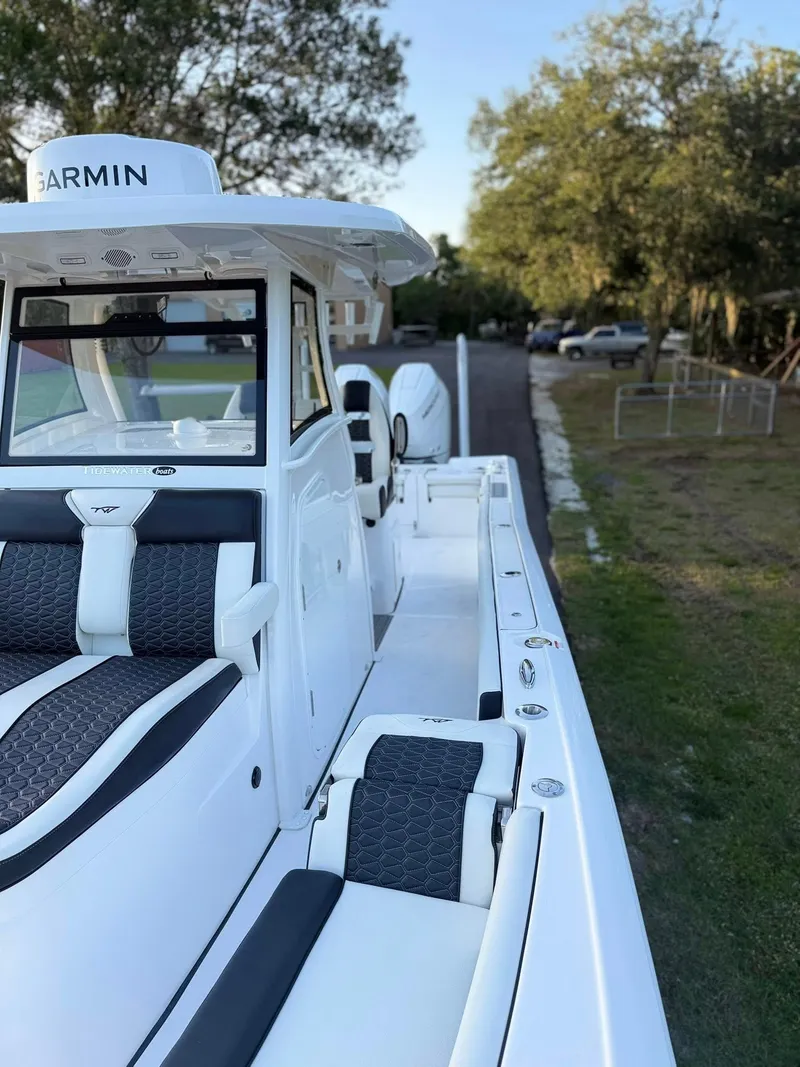 Slide: The Image of 2025 Tidewater 3100 Carolina Bay boat with sleek design and modern features, docked outdoors. - 12