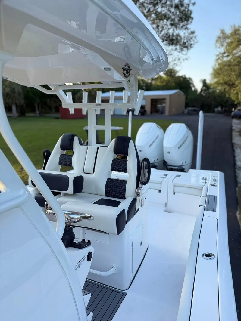 Slide: The Image of 2025 Tidewater 3100 Carolina Bay boat with dual engines and sleek seating. - 13