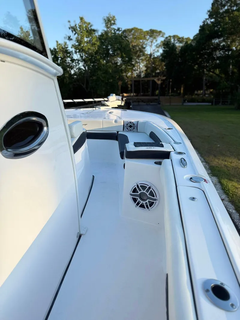 Slide: The Image of 2025 Tidewater 3100 Carolina Bay boat deck with seating and speakers. - 15