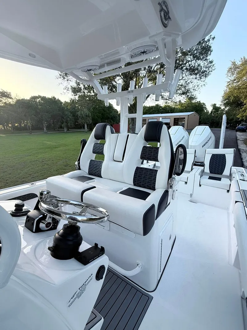 Slide: The Image of 2025 Tidewater 3100 Carolina Bay boat interior with sleek seating and modern controls. - 25