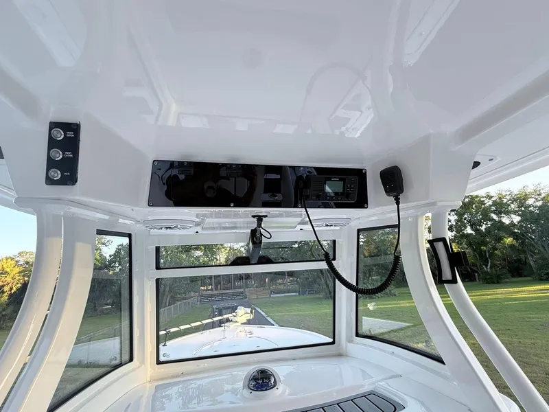 Slide: The Image of 2025 Tidewater 3100 Carolina Bay boat interior with control panel and windows. - 26