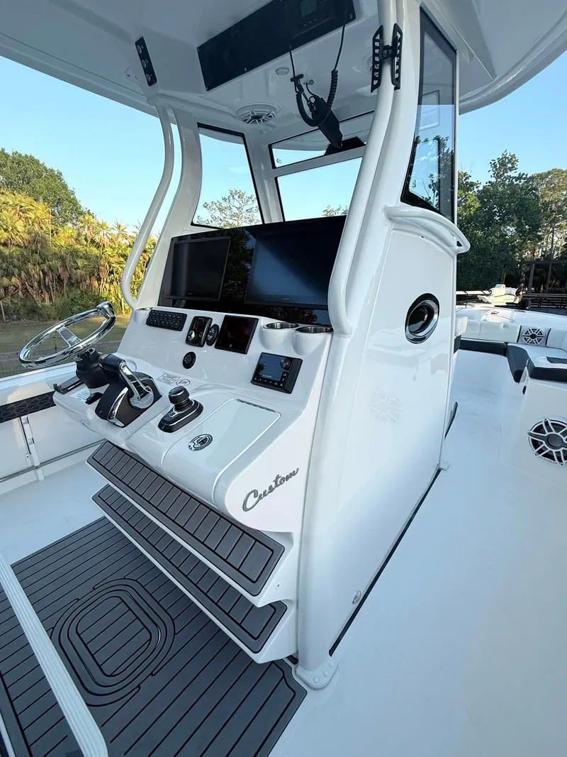 Slide: The Image of 2025 Tidewater 3100 Carolina Bay boat cockpit with advanced navigation controls and sleek design. - 32