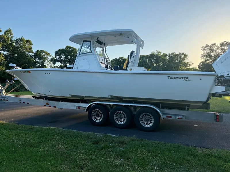 Slide: The Image of 2025 Tidewater 3100 Carolina Bay boat on a trailer, parked outdoors. - 6