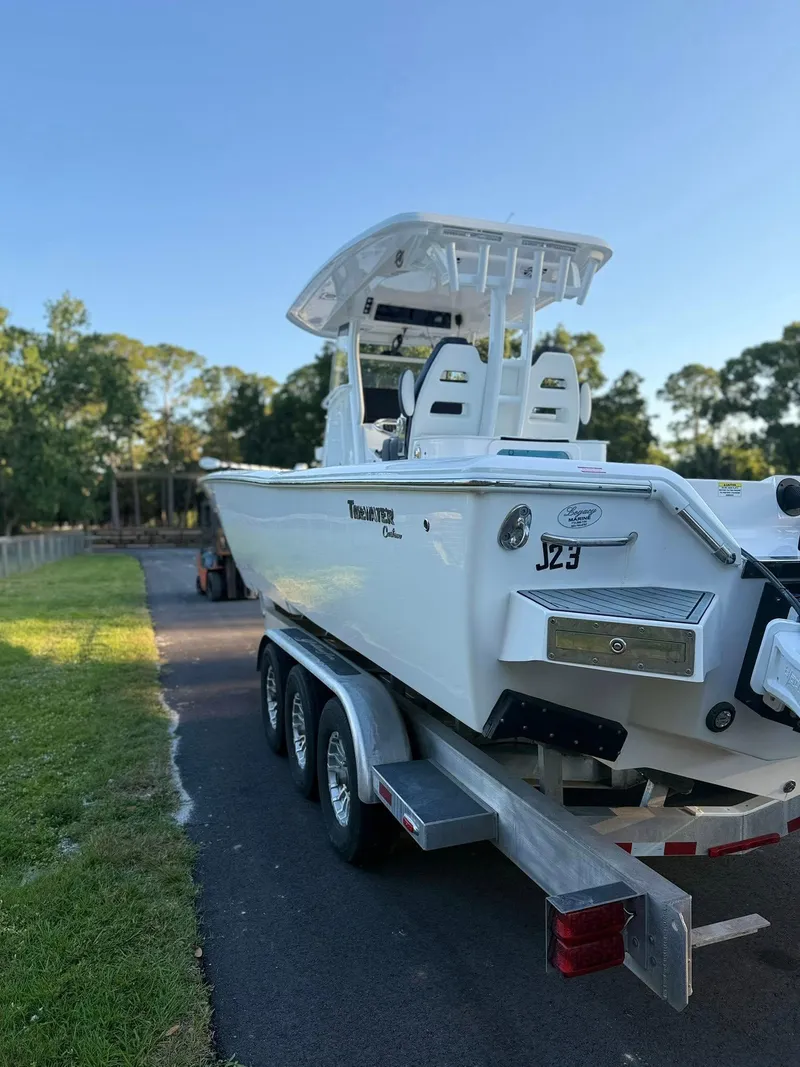Slide: The Image of 2025 Tidewater 3100 Carolina Bay boat on trailer, parked outdoors. - 8