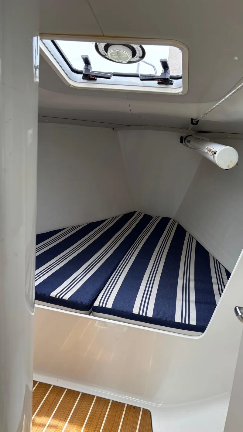 Slide: The Image of Cabin interior of 2012 J Boats J/95 with striped cushions and overhead hatch. - 37