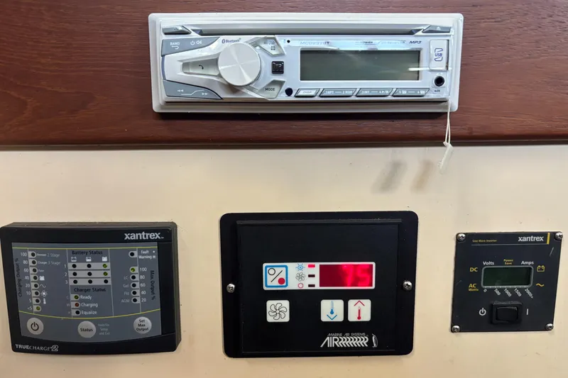 Slide: The Image of Control panel of a 1985 Nordic Tug 32 with various electronic displays and switches. - 12