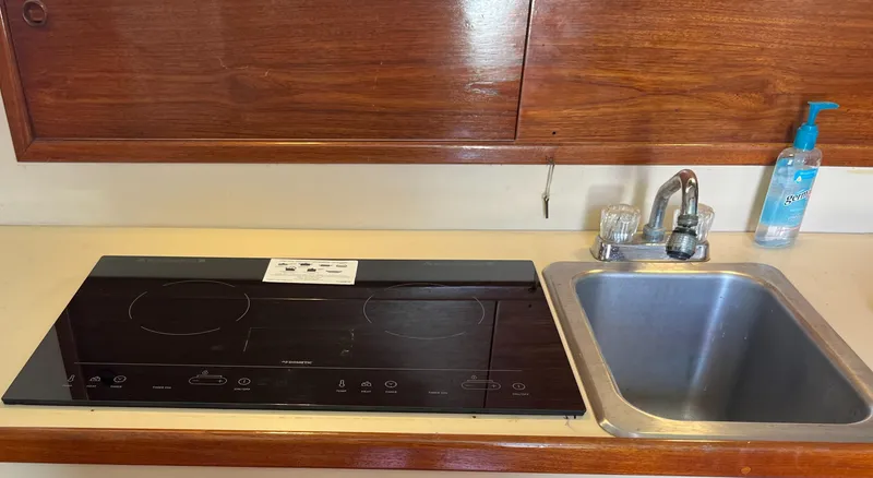 Slide: The Image of Kitchen area of a 1985 Nordic Tug 32 with stove and sink. - 17