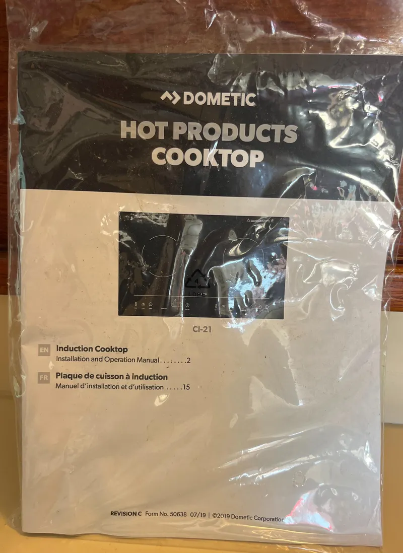 Slide: The Image of Dometic induction cooktop manual in plastic packaging, Nordic Tug 32, 1985 model. - 18