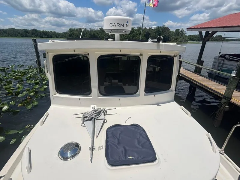 Slide: The Image of 1985 Nordic Tug 32 docked by a lake with Garmin equipment. - 5