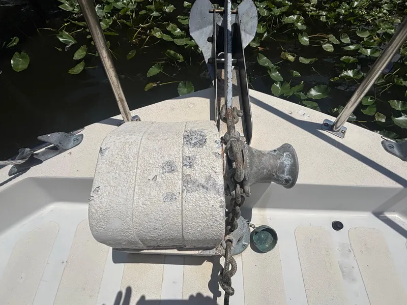 Slide: The Image of Bow of 1985 Nordic Tug 32 with anchor and winch, surrounded by water plants. - 7