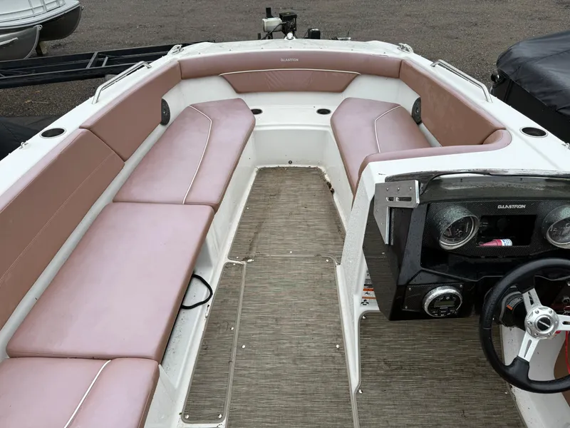 Slide: The Image of 2017 Glastron 205 boat interior with beige seating and steering console. - 3