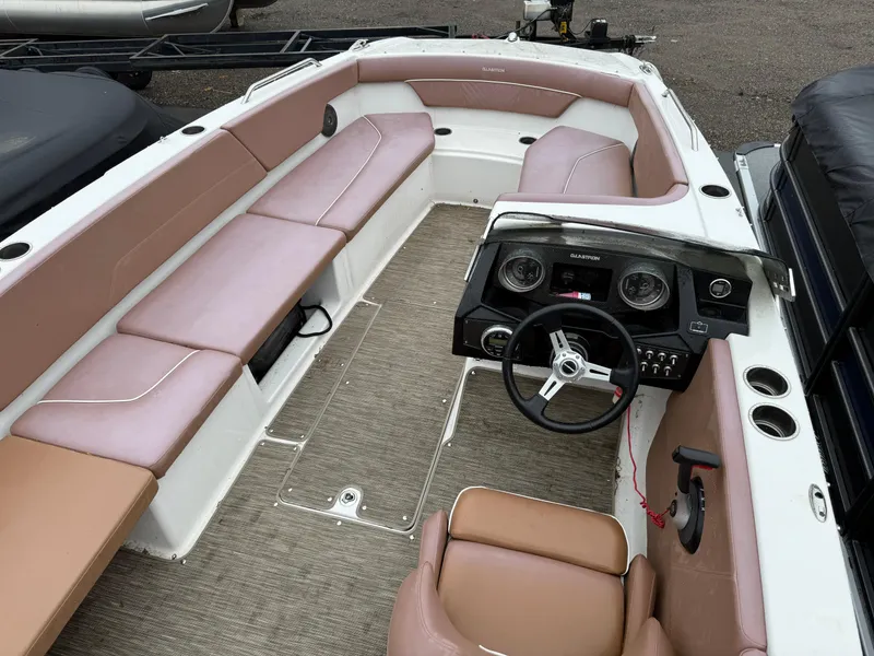 Slide: The Image of 2017 Glastron 205 boat interior with beige seating and steering console. - 5