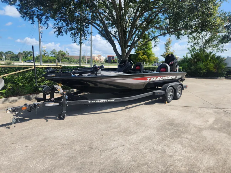 The Image of 2025 Tracker Savage 215 boat on trailer, parked outdoors under a tree. - 0