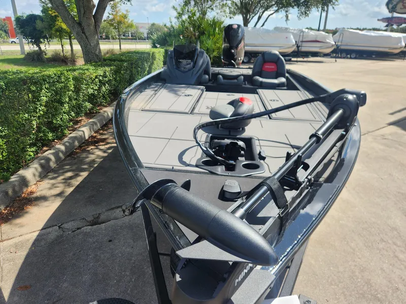 Slide: The Image of 2025 Tracker Savage 215 boat with sleek design and modern features, parked outdoors. - 3