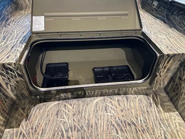 Slide: The Image of 2025 Tracker Grizzly 1650 T Prairie Wings Edition storage compartment with camouflage design. - 7