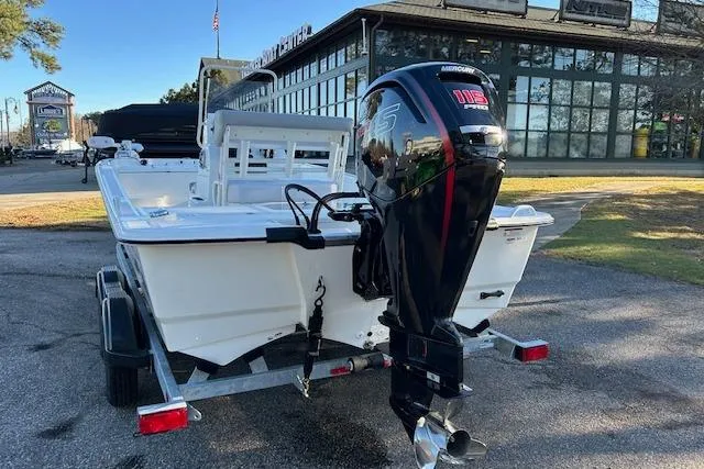 Slide: The Image of 2024 Mako Pro Skiff 19 CC boat with outboard motor on trailer. - 2