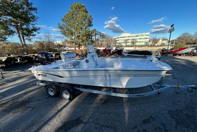 Slide: The Image of 2024 Mako Pro Skiff 19 CC boat on trailer in outdoor setting. - 6