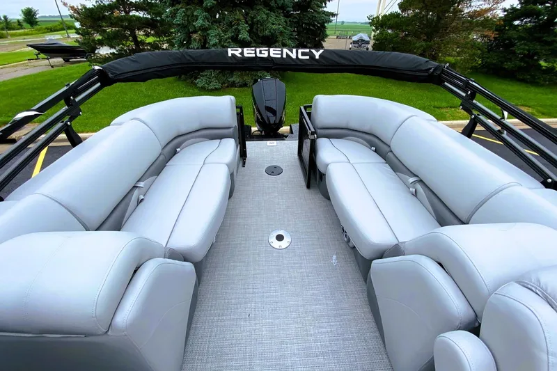 Slide: The Image of 2025 Regency 230 DL3 pontoon boat with spacious seating and sleek design. - 1